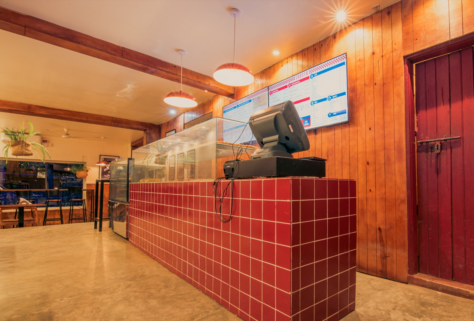 The red-tiled service counter and the menu boards