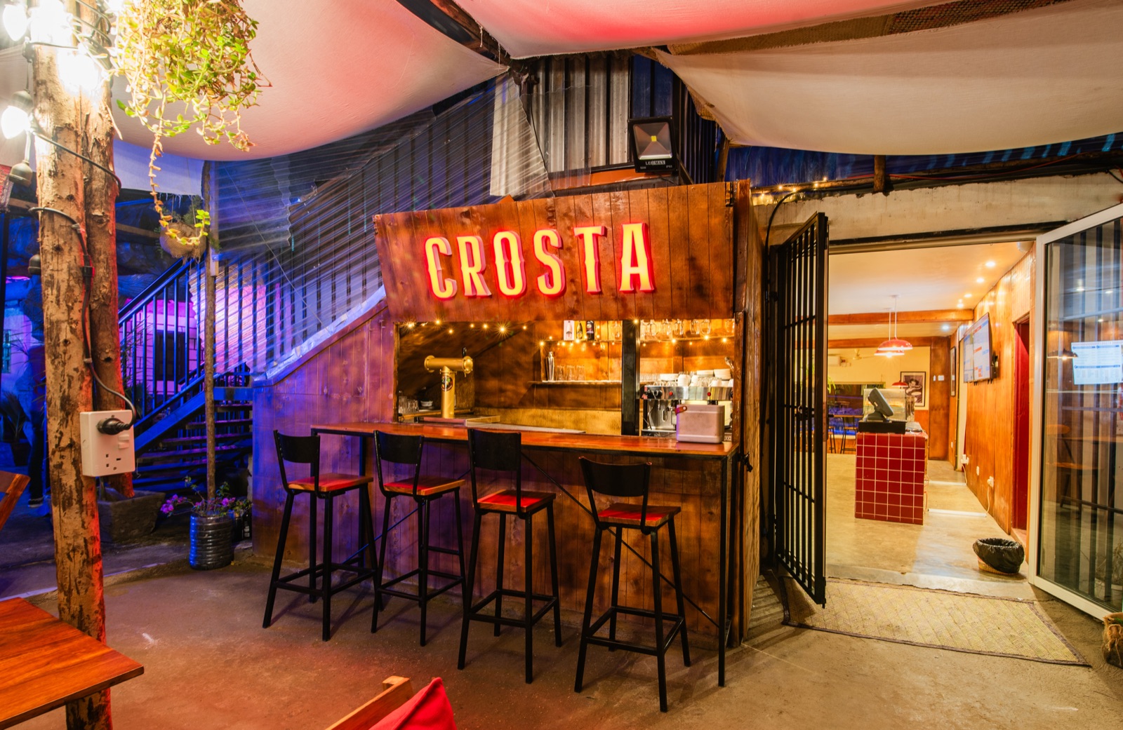 The neon Crosta sign above the garden bar